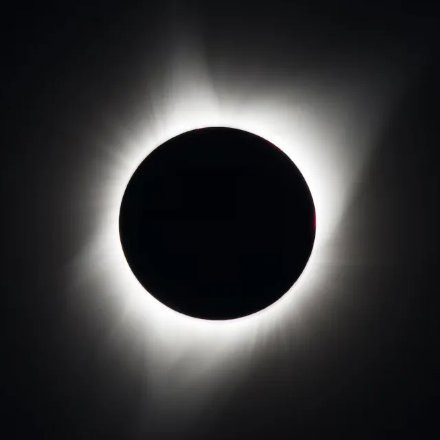 Solar corona during a total eclipse: the Sun's disc fully covered, with the outer atmosphere visible around it.